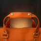 Natural leather duffle bag with warm patina, artisan craftsmanship