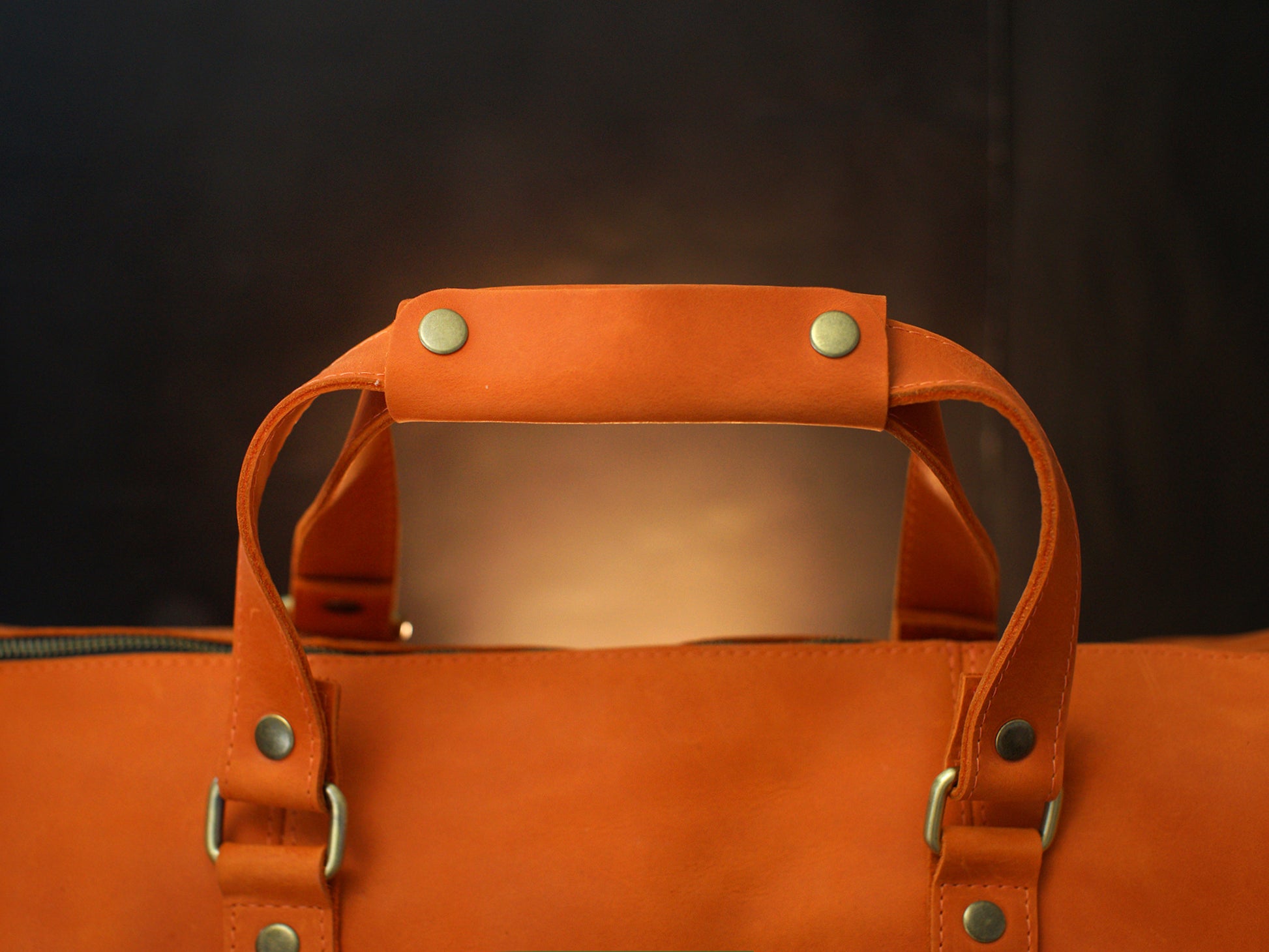 Natural leather duffle bag with warm patina, artisan craftsmanship