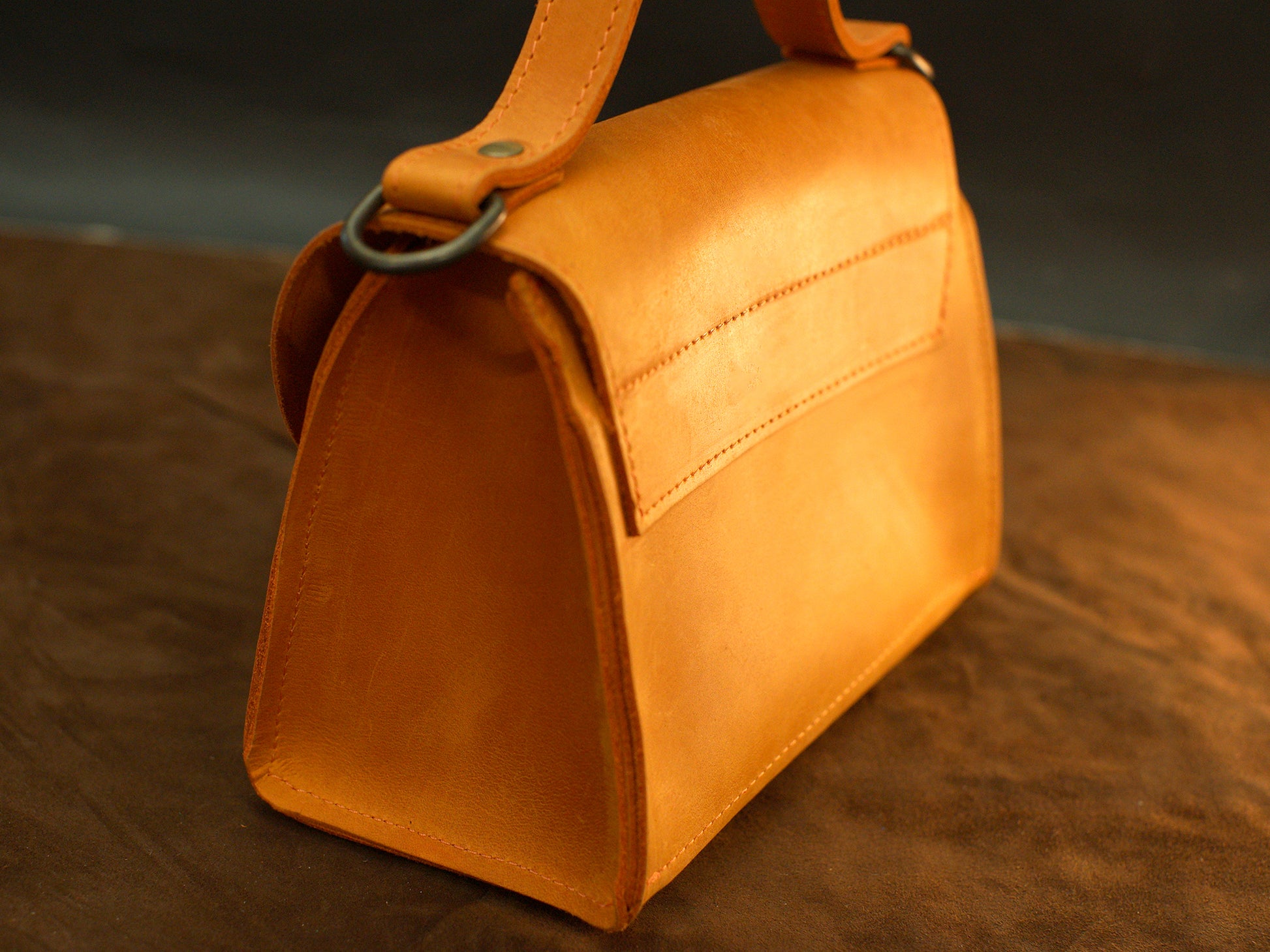 The Signature Flap leather bag worn crossbody, lifestyle editorial photo