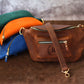 Natural leather crossbody sling with warm patina, artisan craftsmanship