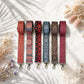 Set of six patterned strap options on a light background with dried flowers.