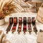Set of colorful bag straps on a table with a phone and flowers in the background