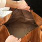 Leather weekender bag shoe compartment detail, separate storage pocket