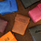 Collection of personalized leather pouches on a wooden surface