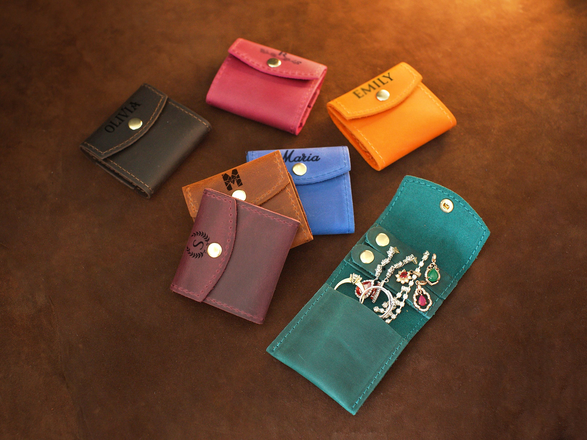 Person holding personalized leather jewelry pouch, lifestyle editorial photo