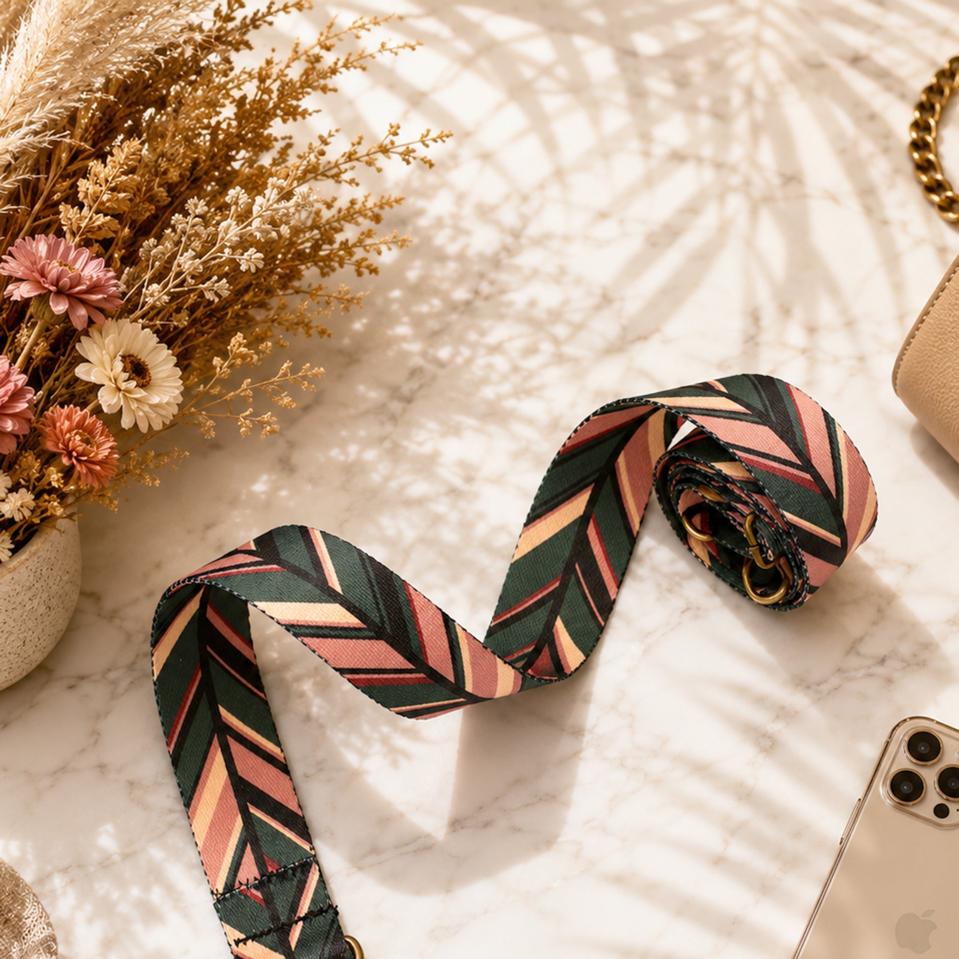 Patterned fabric roll on a textured surface with flowers and phone in the background