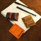Person using personalized leather pen holder on notebook, lifestyle photo