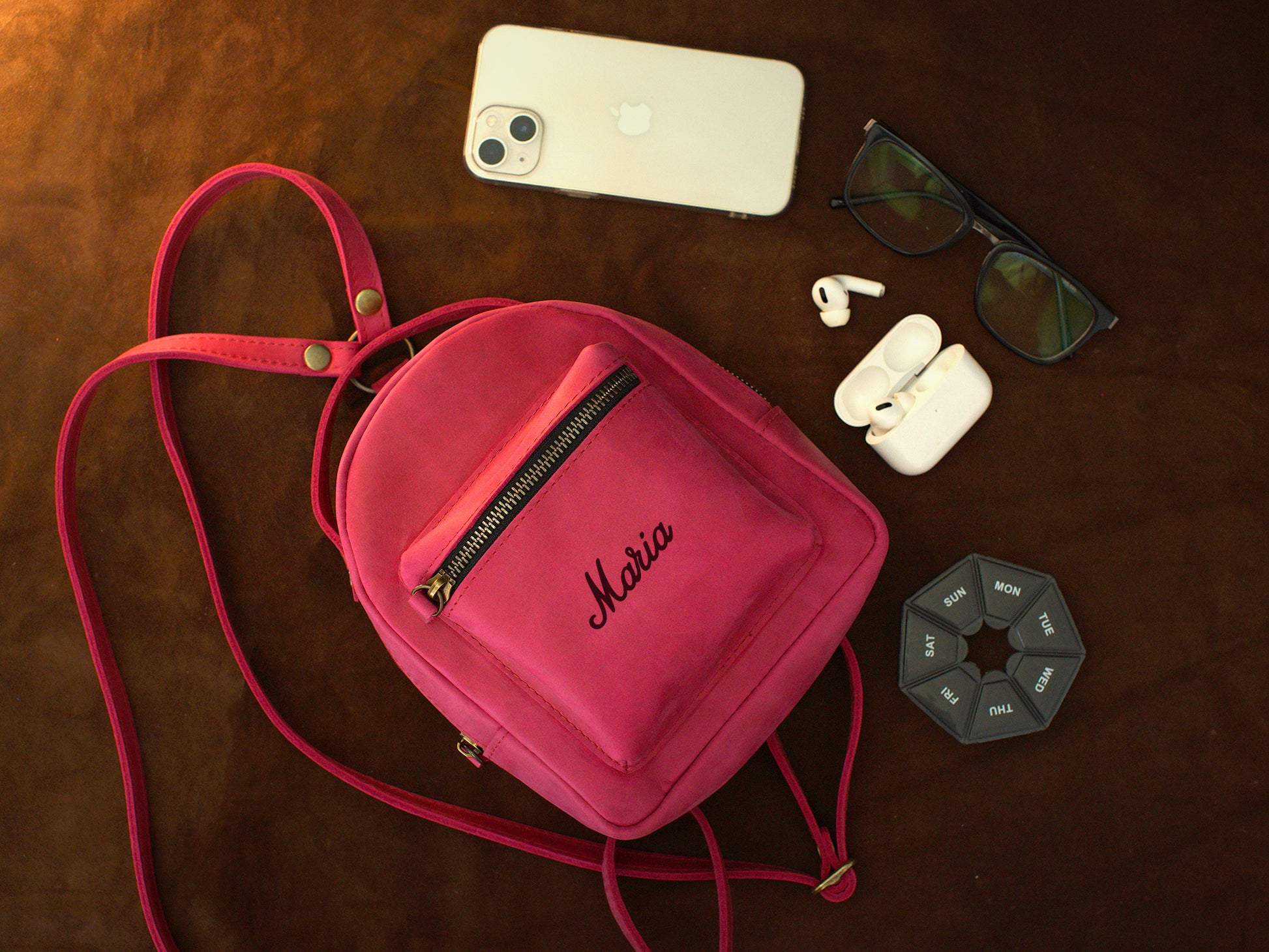 Leather mini backpack zipper and closure detail, durable brass hardware