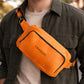 The leather crossbody sling in use outdoors, warm earthy tones