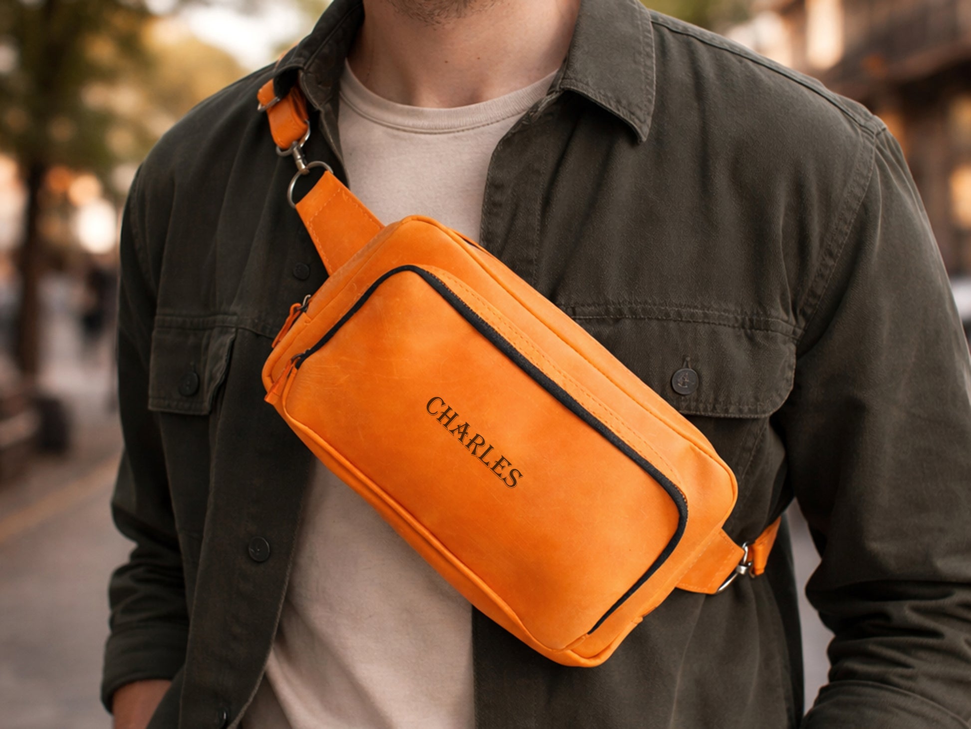 The leather crossbody sling in use outdoors, warm earthy tones