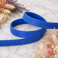 Blue belt on a marble surface with dried flowers