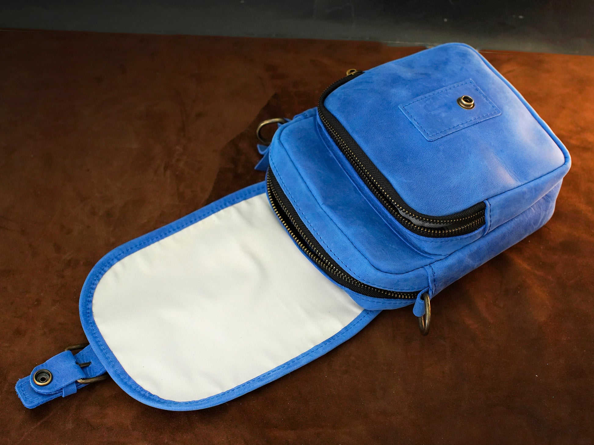 Blue pouch with a zipper on a brown surface