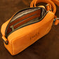 Interior of leather crossbody bag, organized compartments for daily essentials
