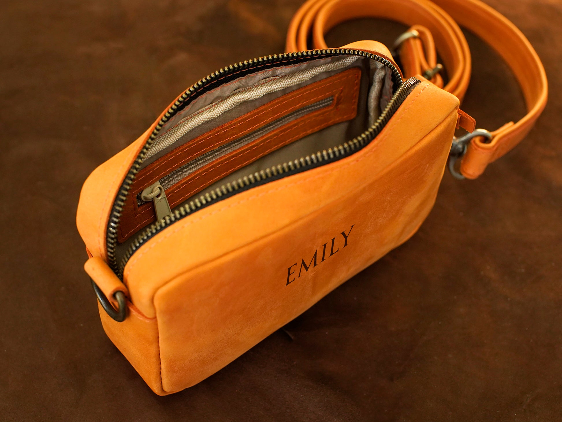 Interior of leather crossbody bag, organized compartments for daily essentials