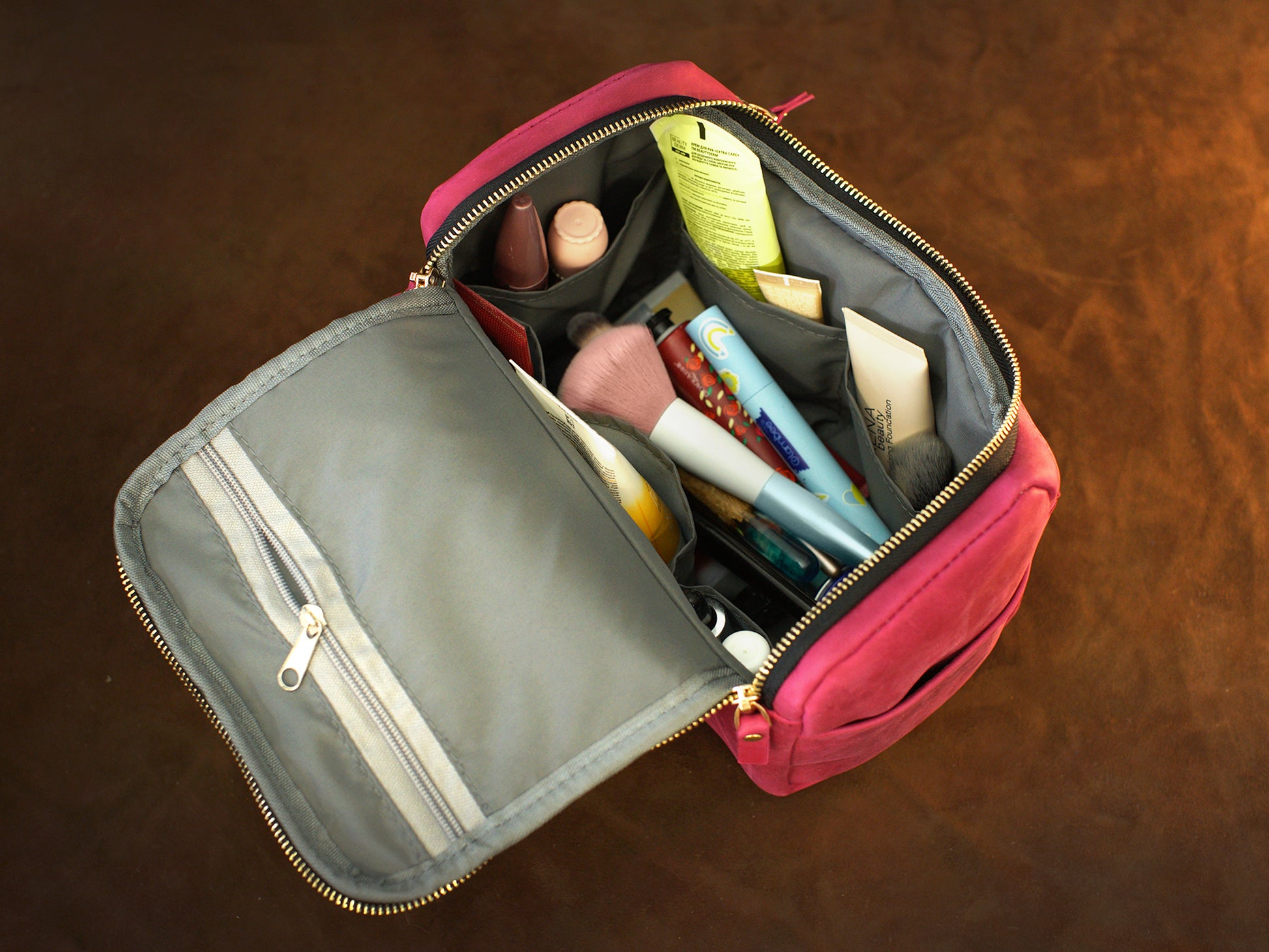The large leather toiletry case in use outdoors, warm earthy tones