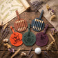 Four personalized golf-themed leather luggage tags arranged on a rustic wooden surface with dried flowers, a map, burlap, and a golf ball. The tags are orange, green, and purple, each with a different golf club engraved or printed on them, and each contains six wooden club shafts.