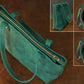 Teal handbag with gold zipper on a brown background