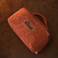 Person holding personalized sherpa toiletry bag, lifestyle editorial photo