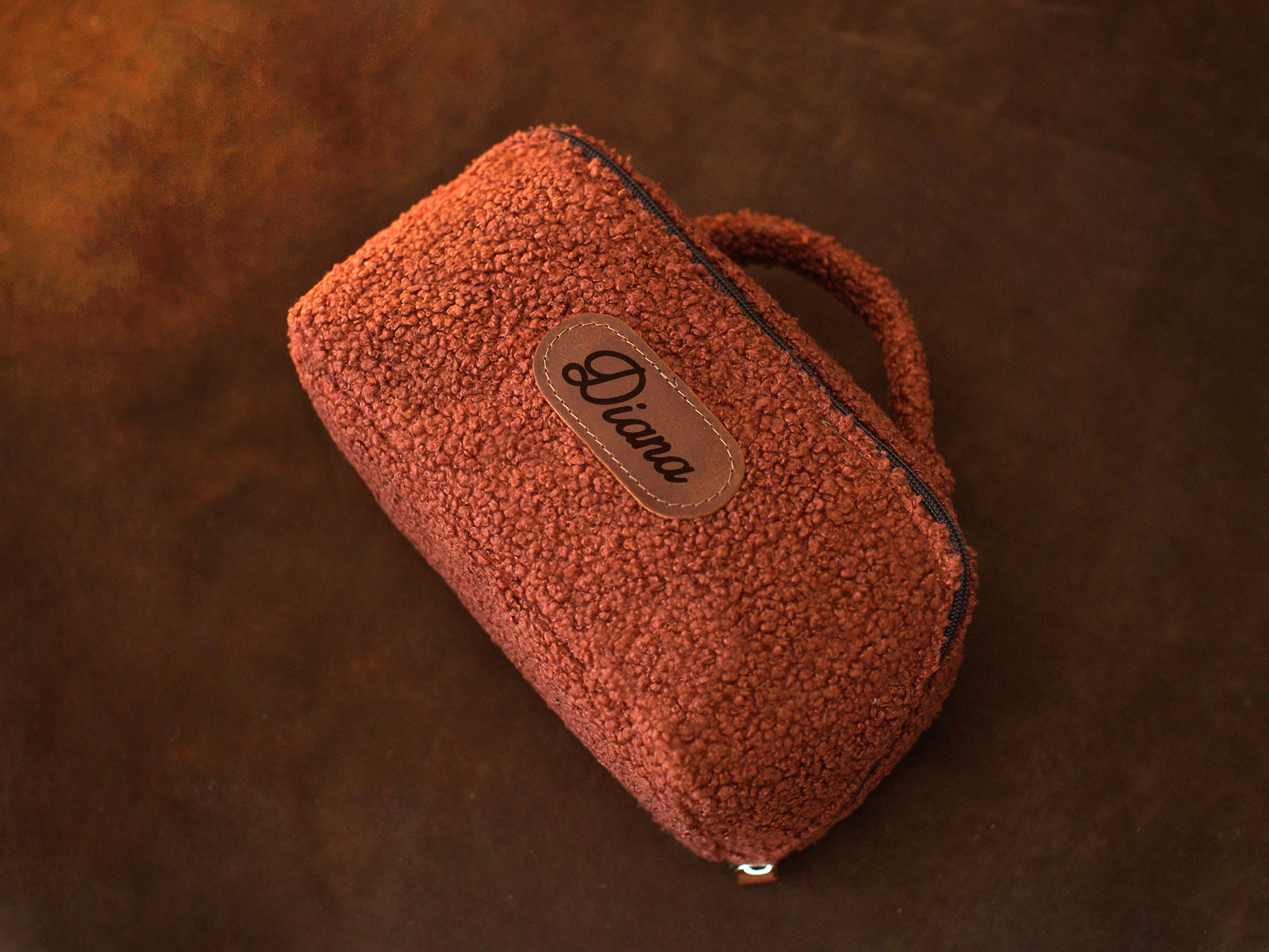 Person holding personalized sherpa toiletry bag, lifestyle editorial photo