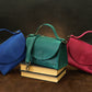Person carrying personalized leather handbag, street style shot