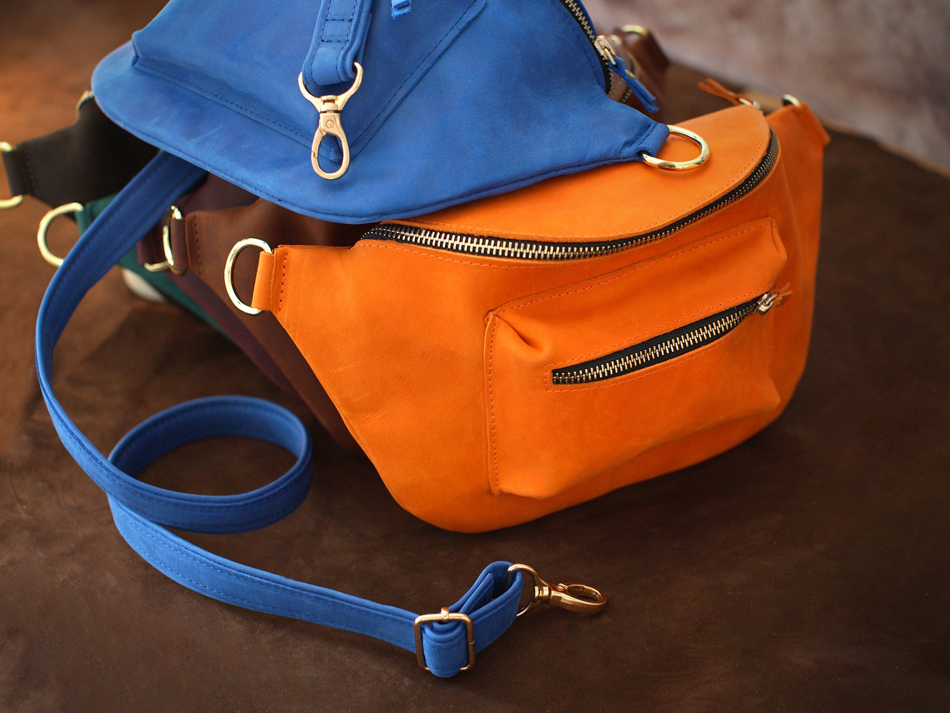 The leather crossbody sling in use outdoors, warm earthy tones