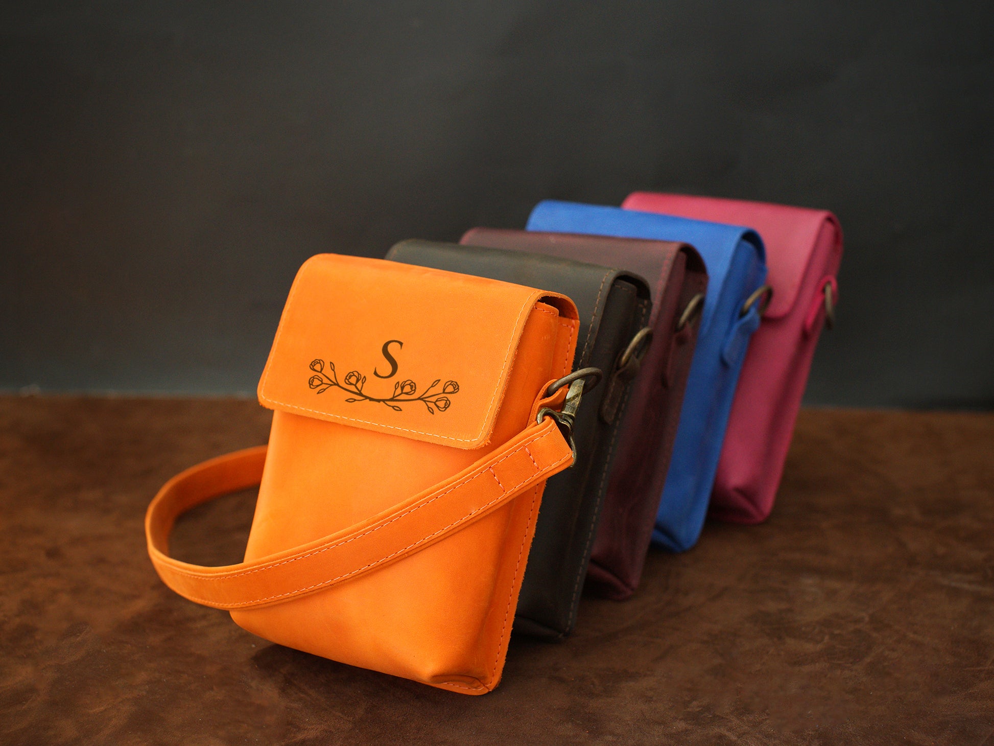 Collection of personalized leather crossbody bags with engravings