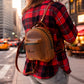 Person wearing personalized leather mini backpack, street style shot