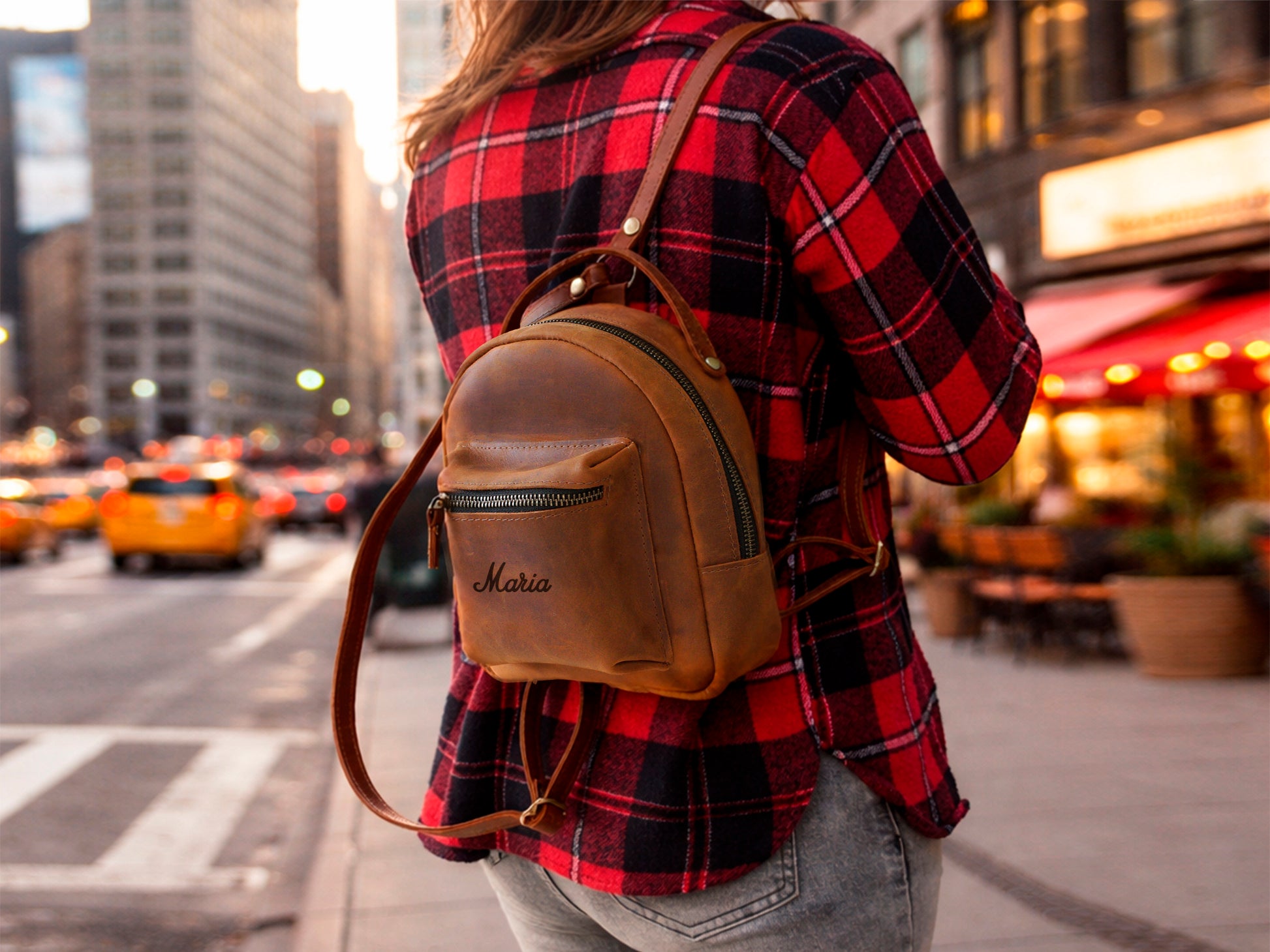 Person wearing personalized leather mini backpack, street style shot