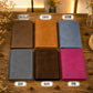 Six leather bifold wallets arranged in a 2x3 grid on a wooden surface, labeled with color names: Chocolate, Tawny, Denim, Gray, Olive, and Pink. Each wallet is shown closed, and the labels are placed above or below the corresponding item.