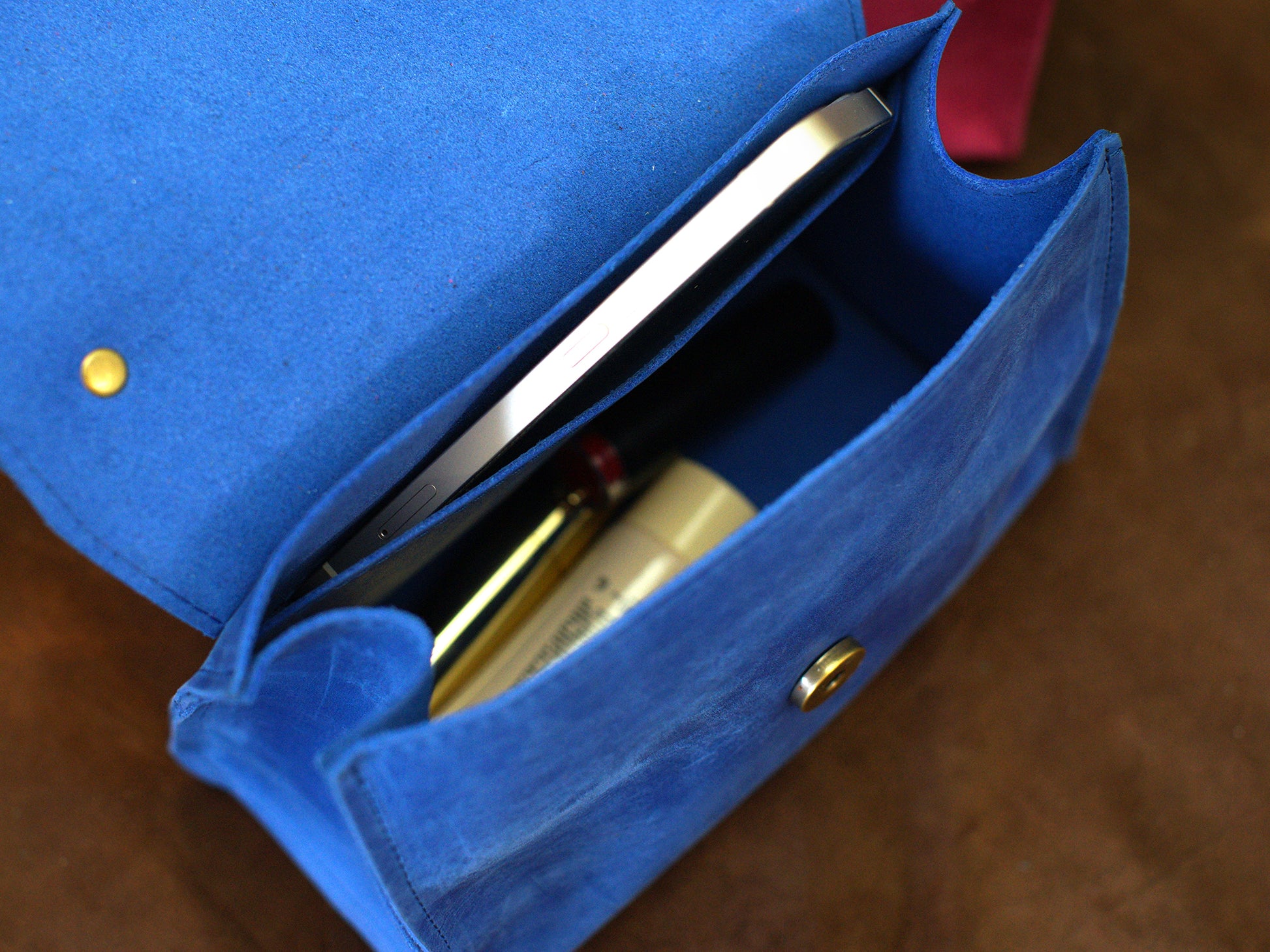 The Signature Flap leather bag in use outdoors, warm earthy tones