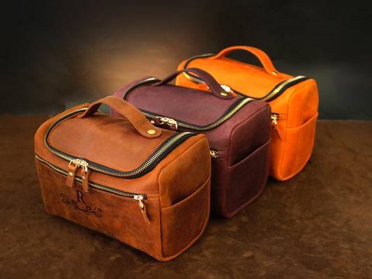 Large leather toiletry case with personalized engravings, collection flat lay