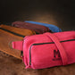 Multiple leather sling bags with monogram initials on textured surface