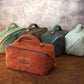 Four small bags in different colors on a wooden surface with a blurred background