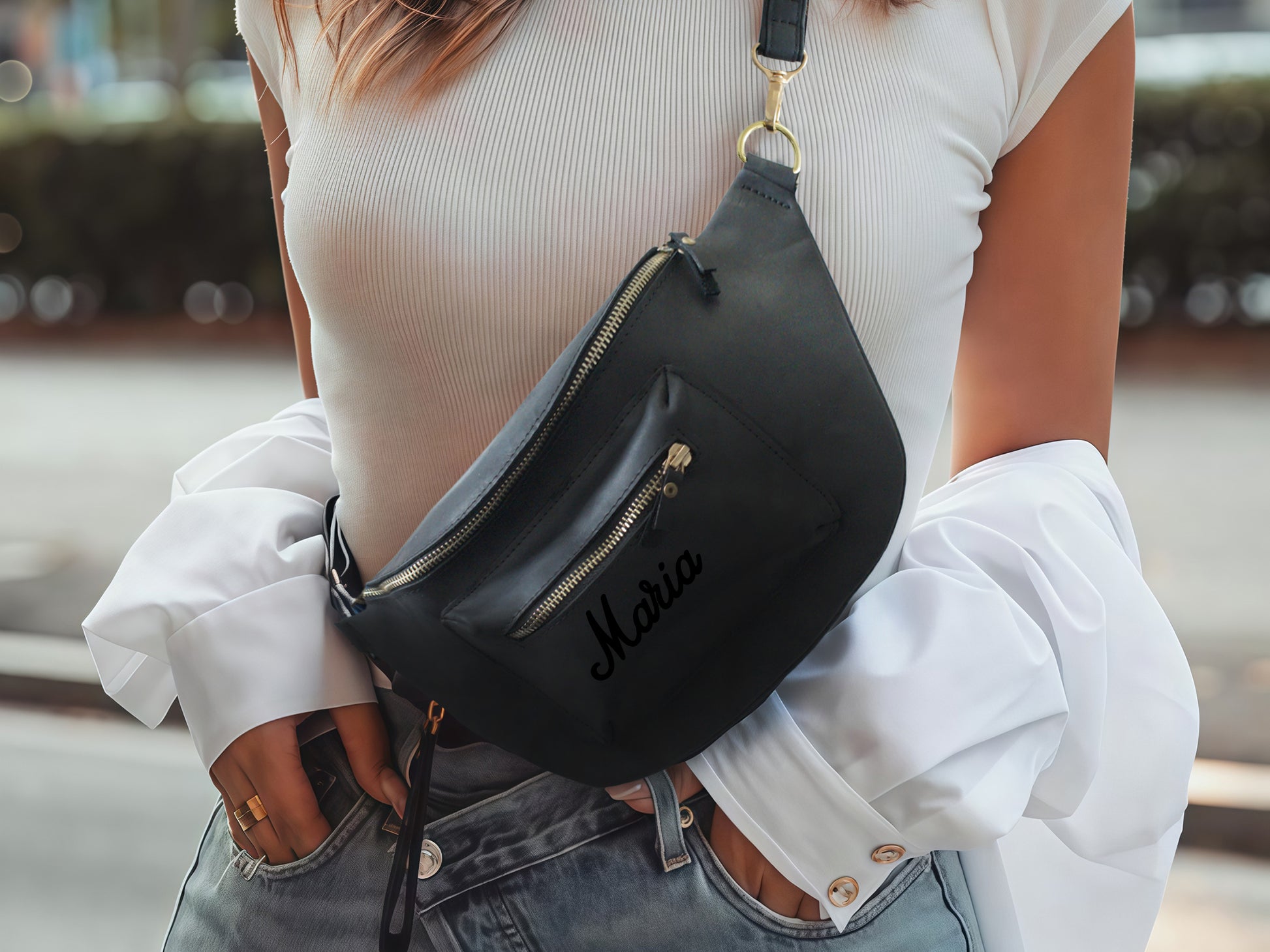 Multiple leather sling bags with monogram initials on textured surface