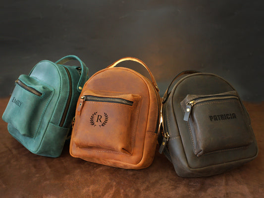 Leather mini backpack collection with personalized engravings, lifestyle flat lay