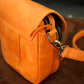 Close-up of a yellow leather bag with a zipper on a blurred background