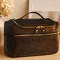 Multiple leather cosmetic bags with monogram initials on textured surface