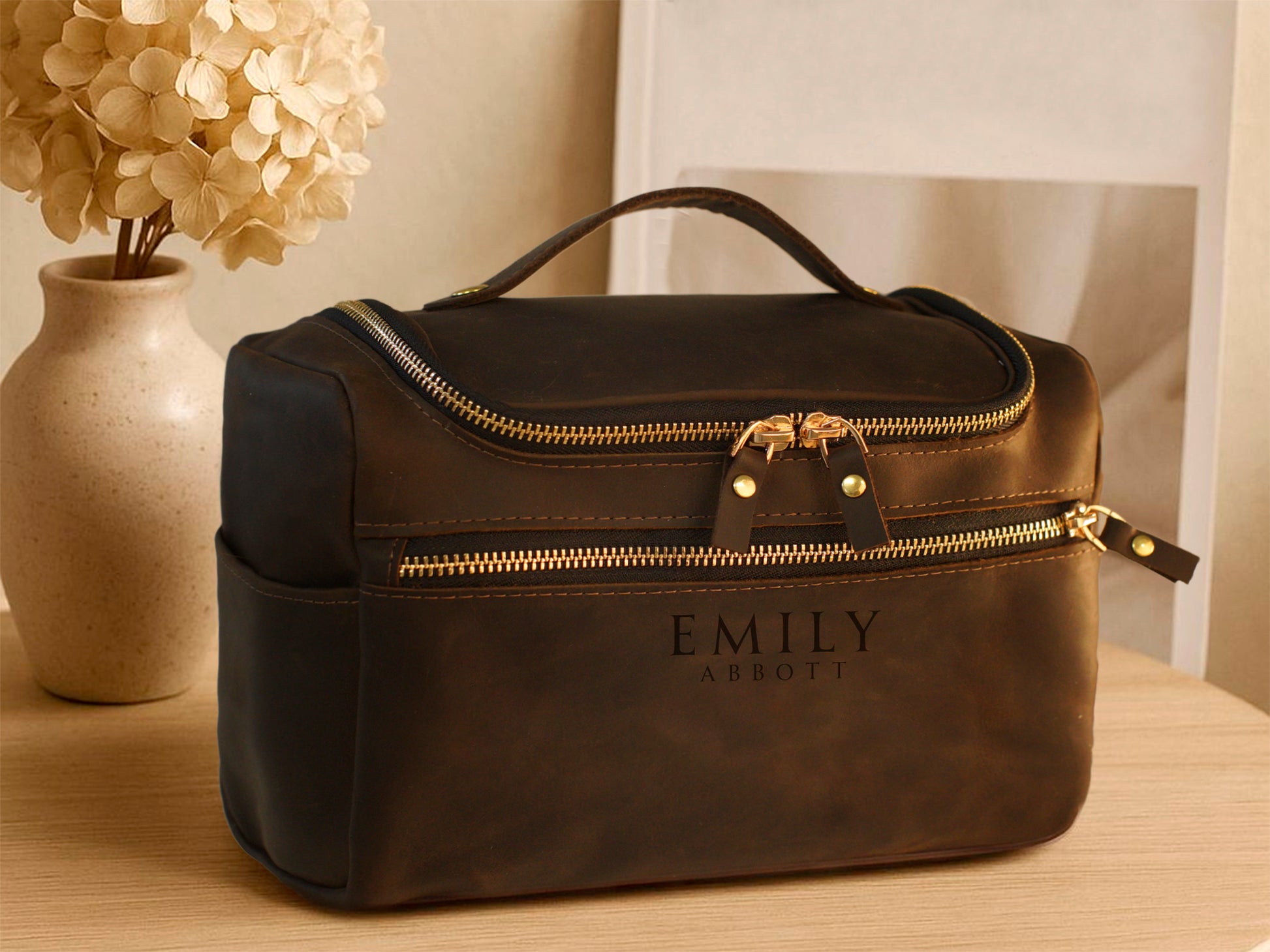 Multiple leather cosmetic bags with monogram initials on textured surface