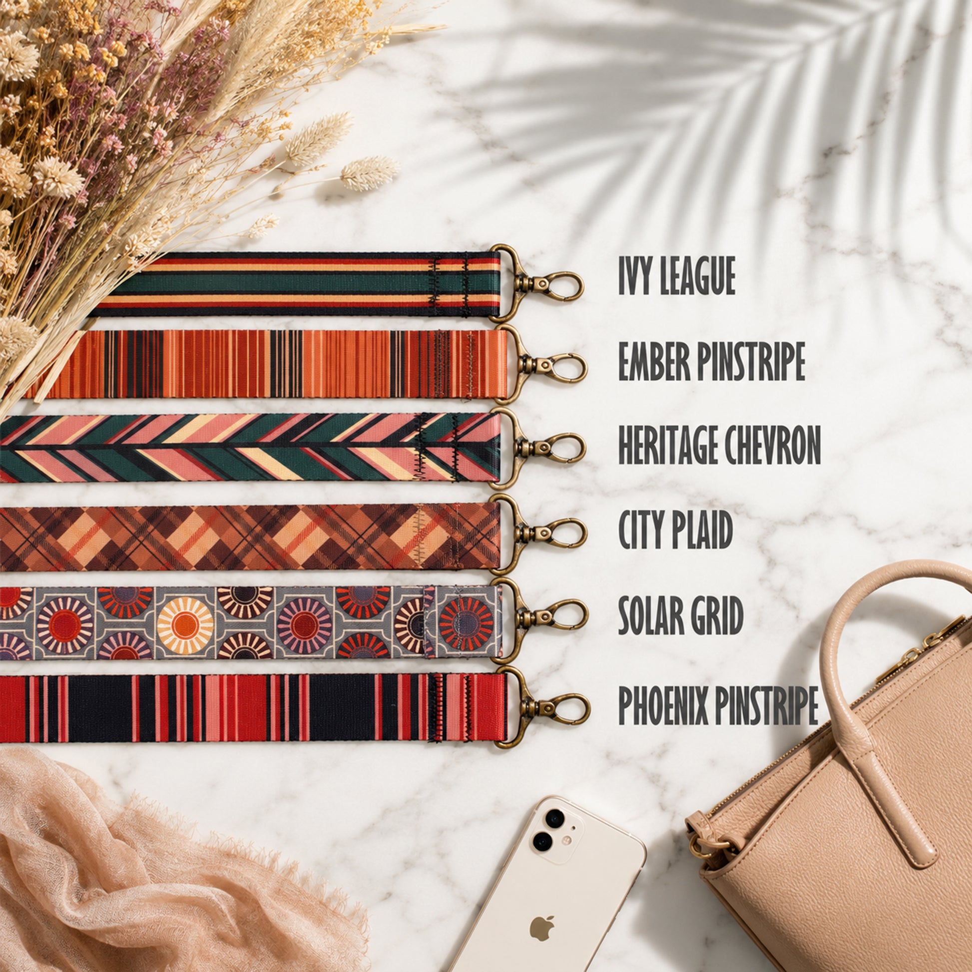 Set of colorful strap designs with a beige handbag and phone on a light background