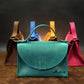 Leather handbag collection with personalized engravings, lifestyle flat lay