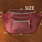 Leather sling bag collection with personalized engravings, lifestyle flat lay