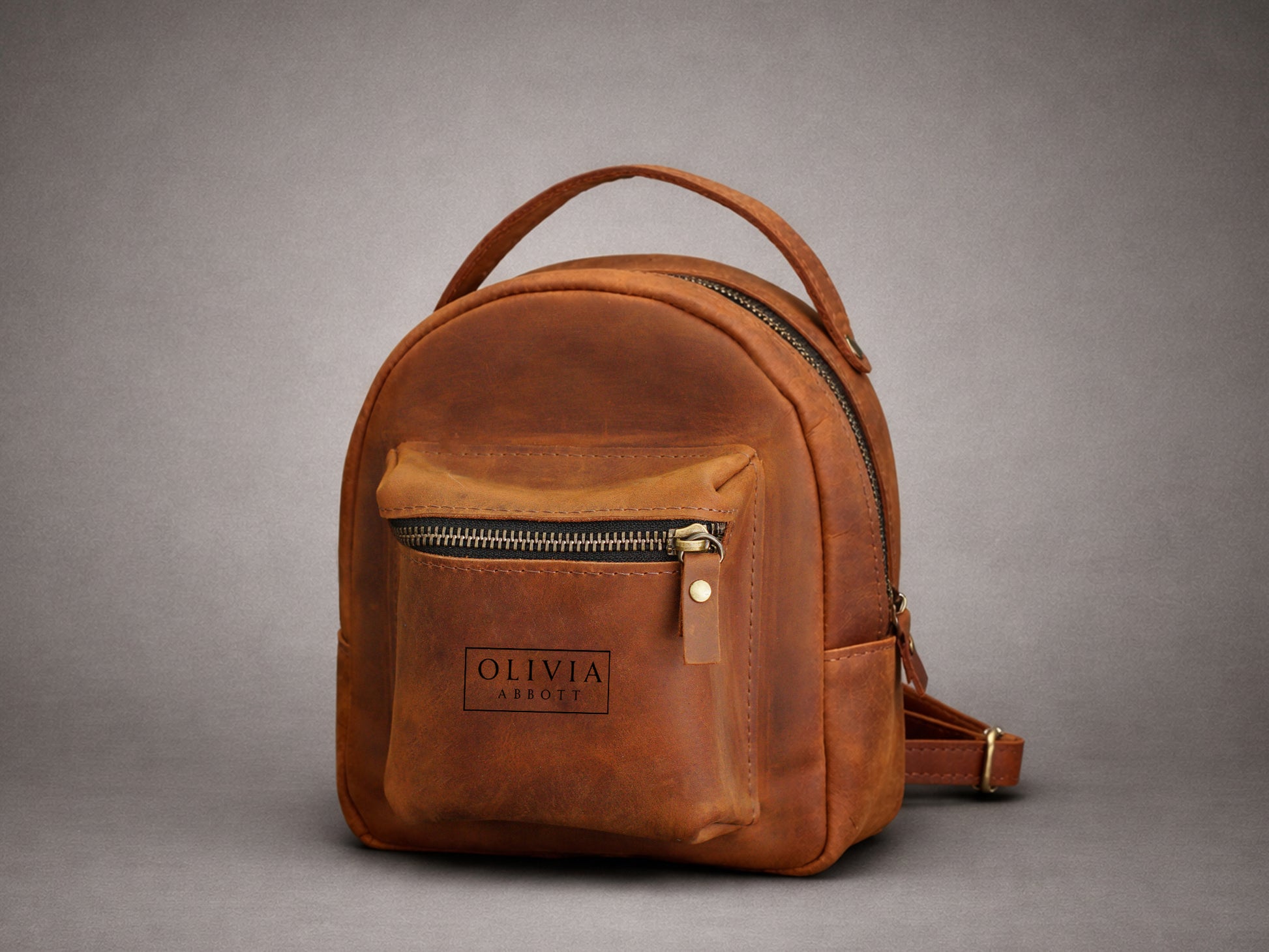 Leather mini backpack with custom name engraving, warm brown tone