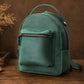 Teal backpack on a wooden surface with a brown background