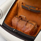Brown leather duffel bag in the trunk of a vintage car