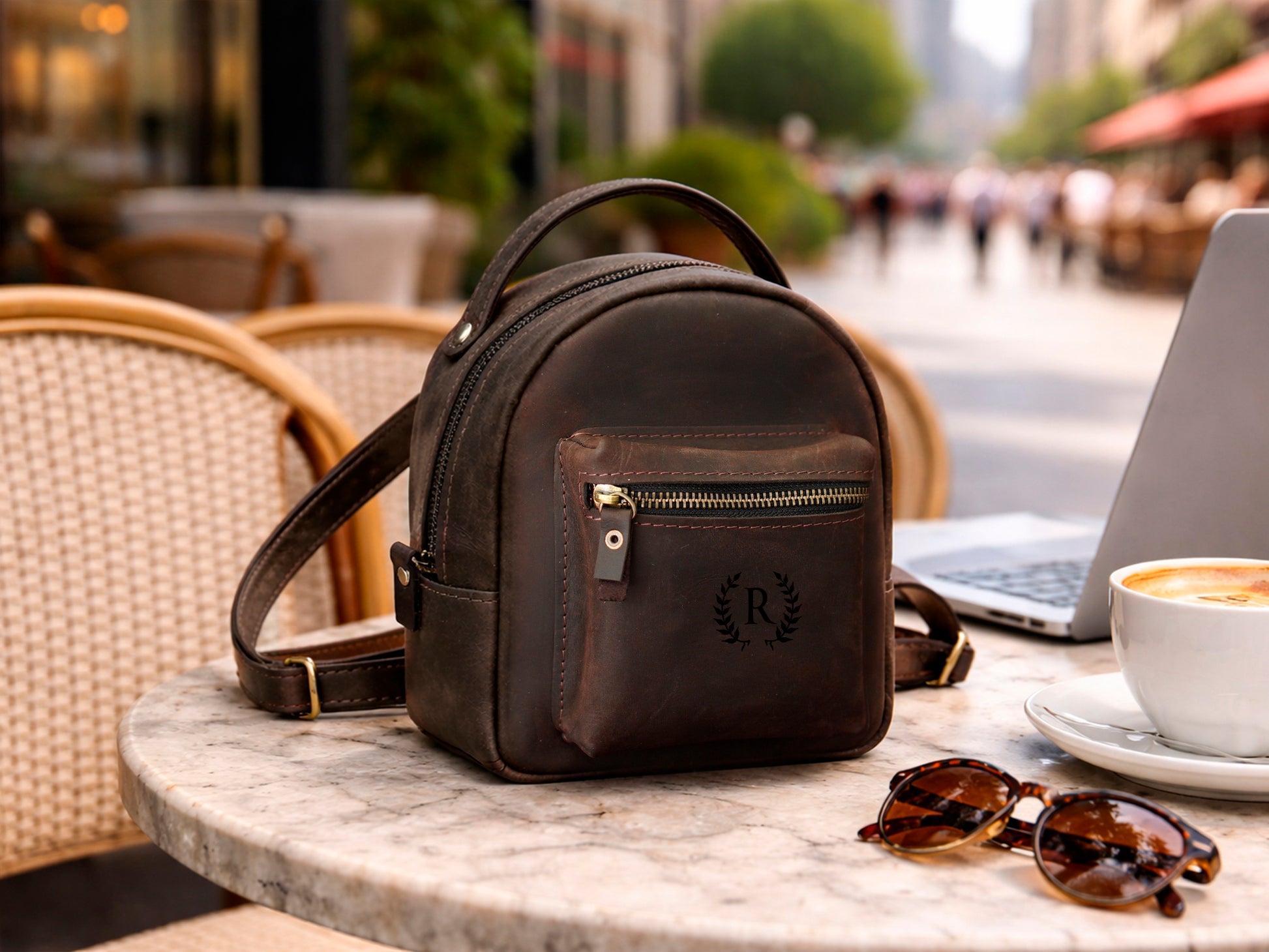Multiple leather mini backpacks with monogram initials on textured surface