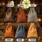 Six faux leather drawstring pouches in different colors are arranged on a rustic wooden table with labels underneath: Chocolate, Brown, Gray, Tawny, Denim, and Yellow.