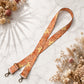 Floral patterned strap on a marble surface with dried flowers