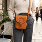 Brown leather vertical crossbody bag with custom monogram engraving, front view