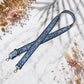 Blue floral patterned strap on a marble surface with dried flowers