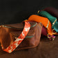 Set of leather bags with colorful straps on a dark background
